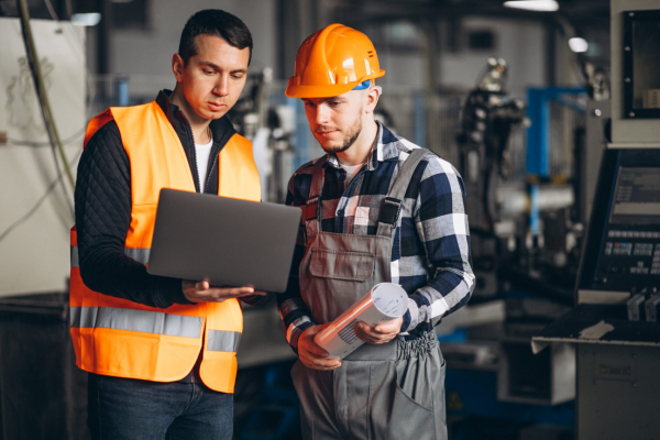 Deux techniciens devant les plans Photo représentant deux techniciens vérifiant les plans avant de débuter le chantier